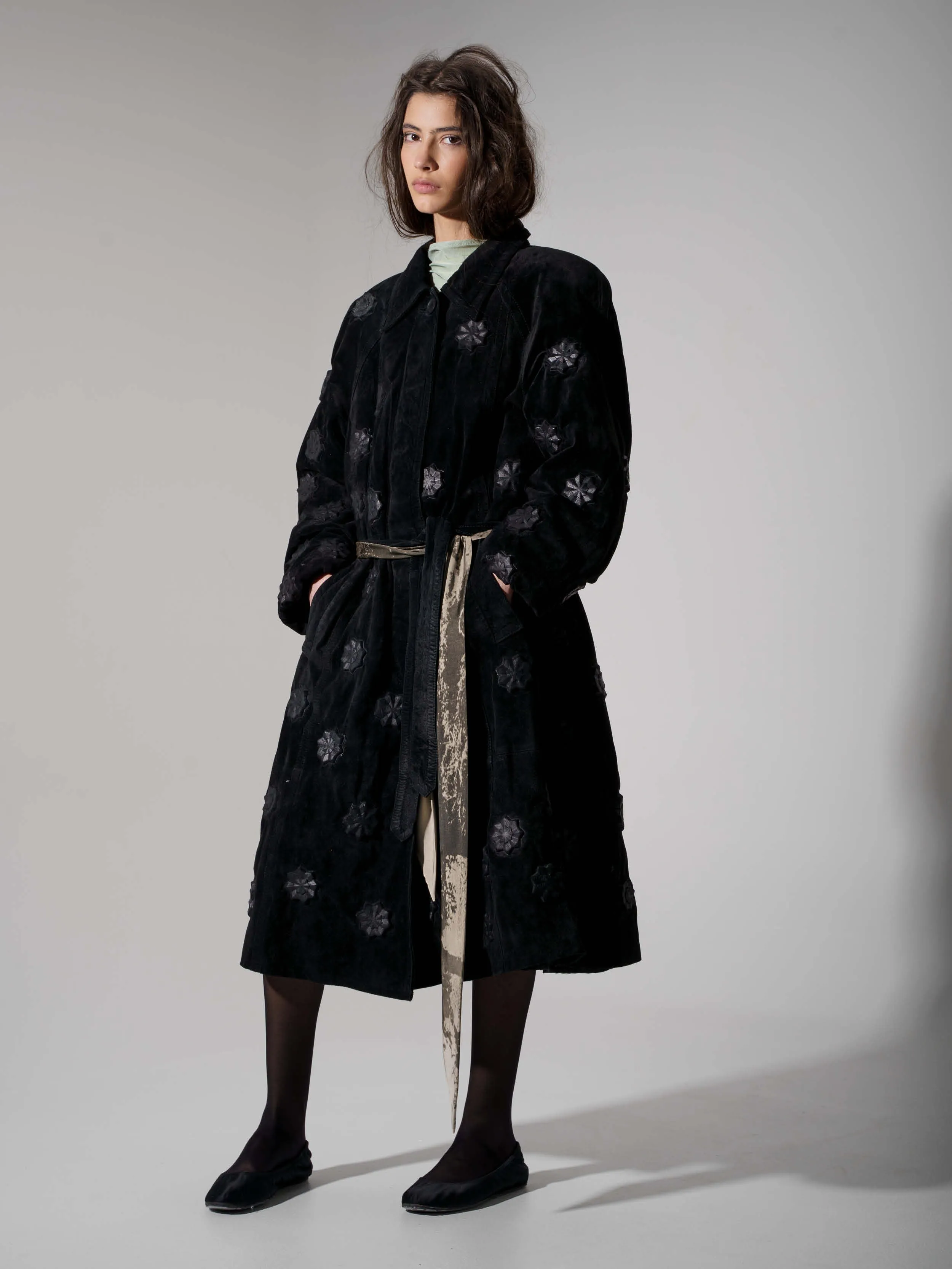 Upcycled leather coat with structures